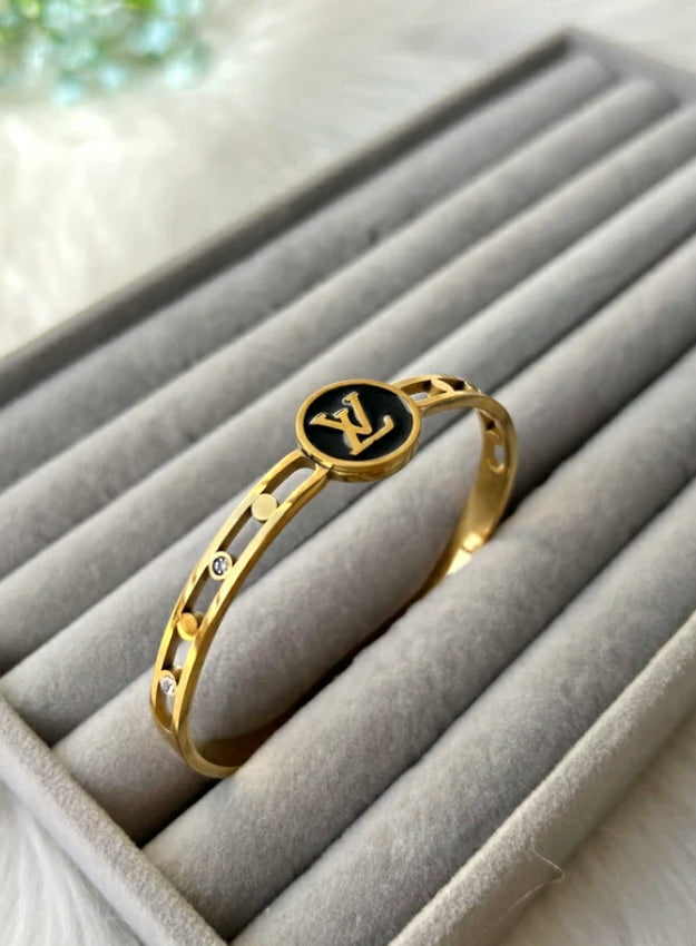 Black stainless steel bracelet accented with gold LV motifs.